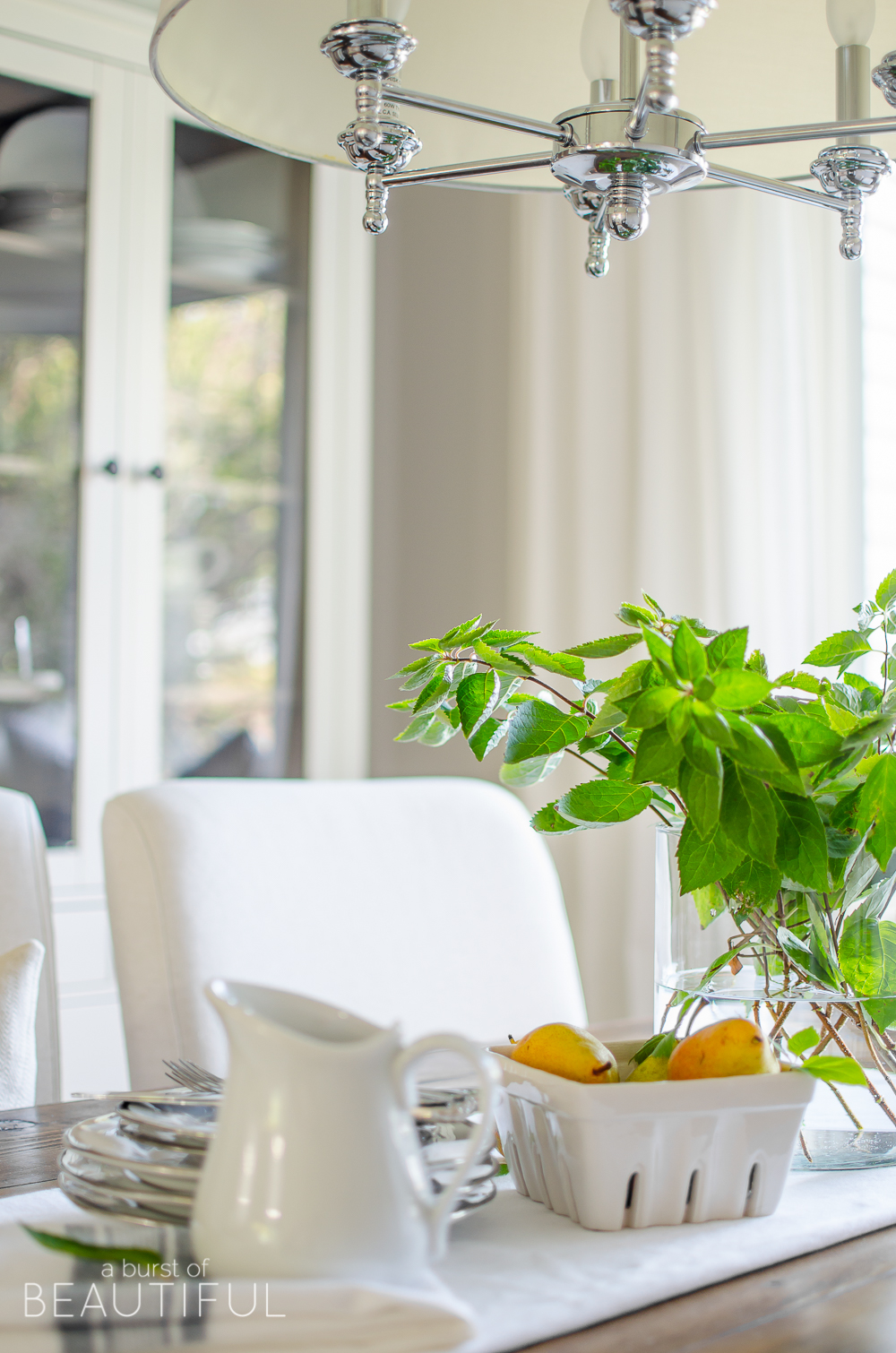 A DIY farmhouse dining table and window bench take center stage in this modern farmhouse dining room.