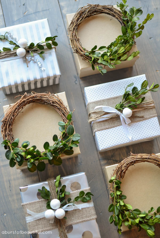 A simple homemade mini boxwood wreath creates a festive gift topper for the holidays. 