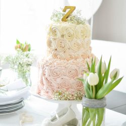 A beautiful pink ombre rosette cake takes centre-stage at a whimsical first birthday party | A Burst of Beautiful