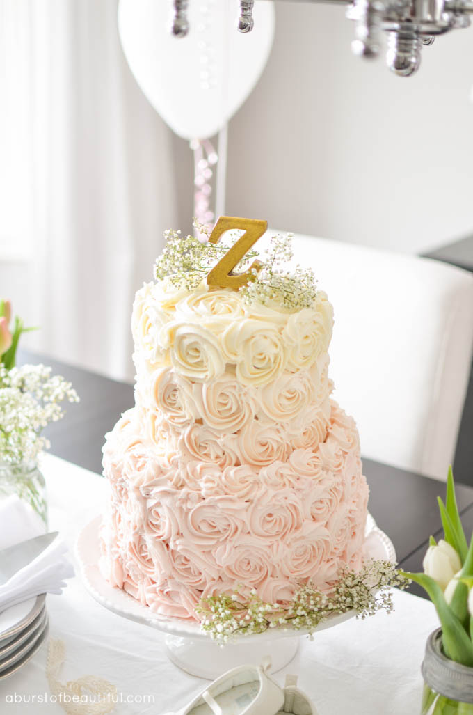 A beautiful pink ombre rosette cake takes centre-stage at a whimsical first birthday party | A Burst of Beautiful 