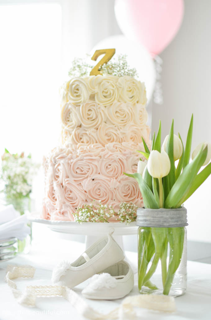 A beautiful pink ombre rosette cake takes centre-stage at a whimsical first birthday party | A Burst of Beautiful 