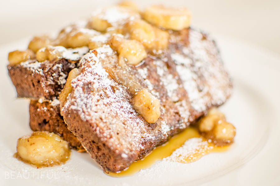 Homemade banana bread and caramelized bananas make this delectable Bananas Foster French Toast the perfect addition to breakfast, brunch or dessert. Find the recipe at www.aburstofbeautiful.com
