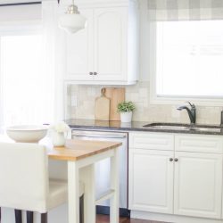 A window valance made from neutral buffalo check fabric compliments this simple farmhouse kitchen perfectly. Visit aburstofbeautiful.com for the full tutorial | A Burst of Beautiful