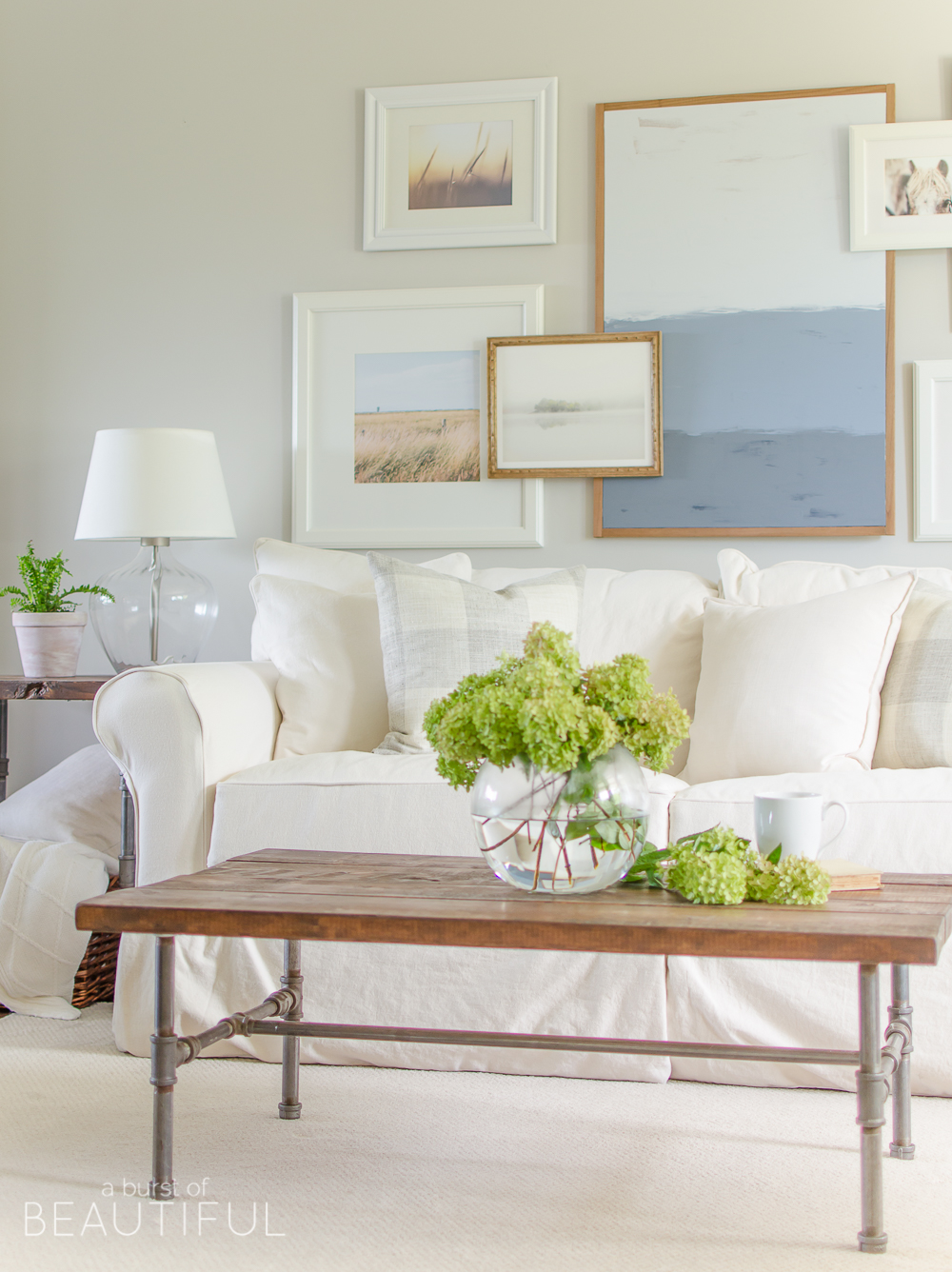 A white slipcovered sofa creates a casual and relaxed feel in this modern farmhouse