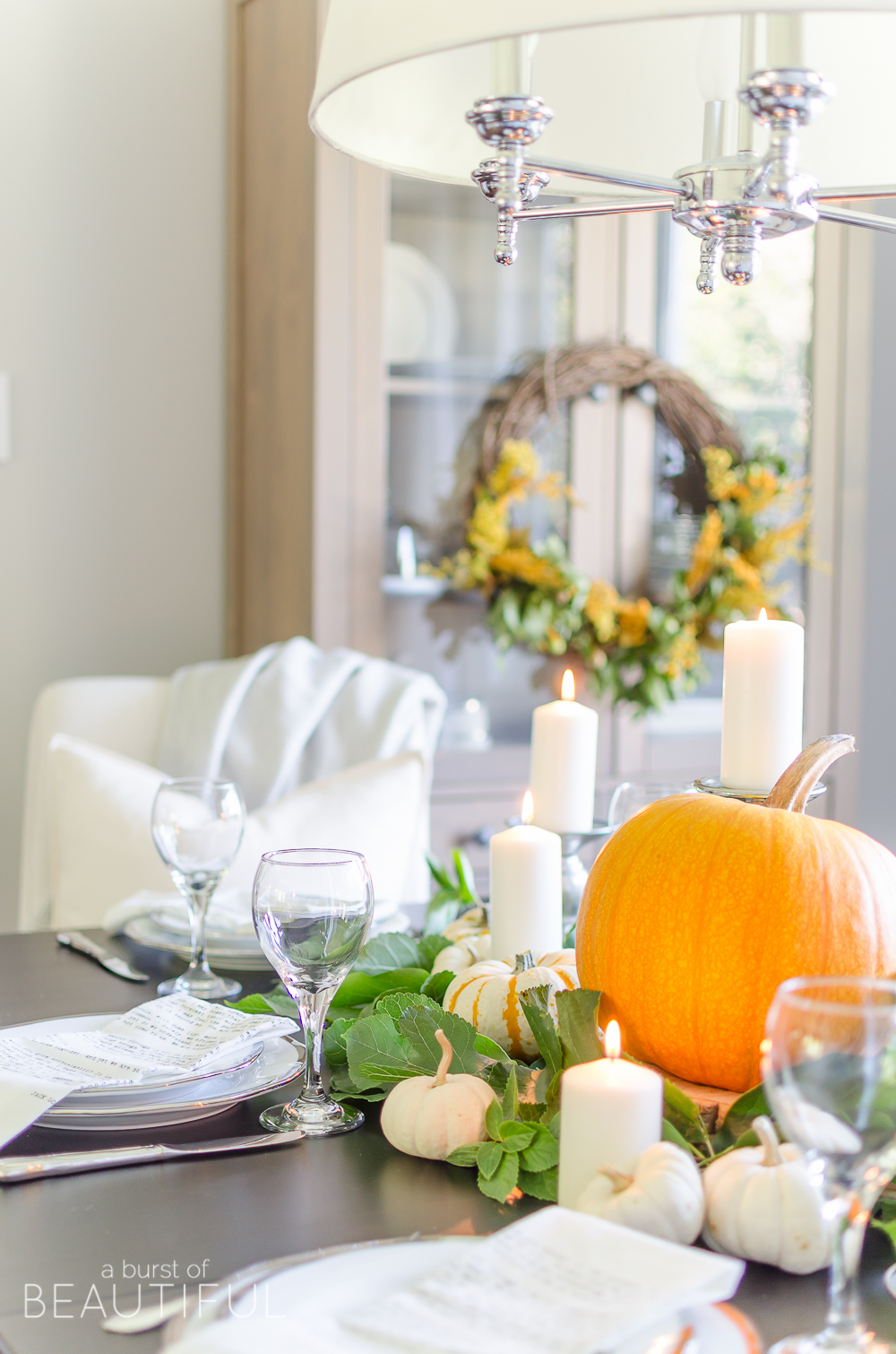 Create a simple and classic fall tablescape using mini pumpkins, fresh greenery and candles.