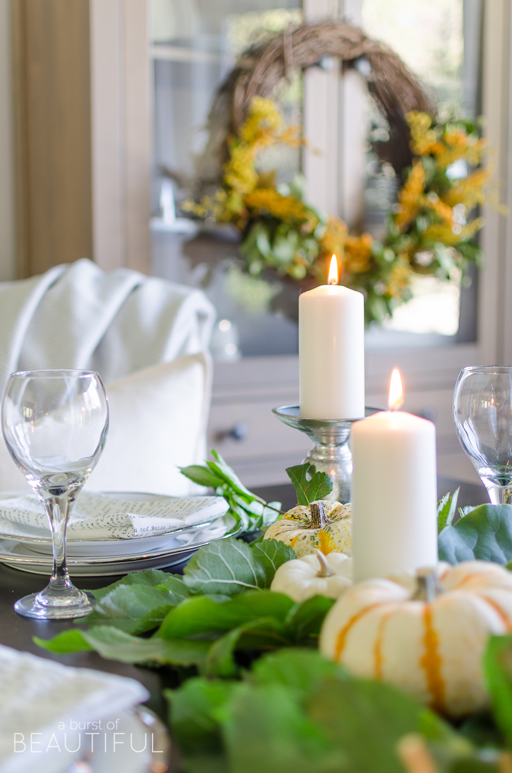 Create a simple and classic fall tablescape using mini pumpkins, fresh greenery and candles.