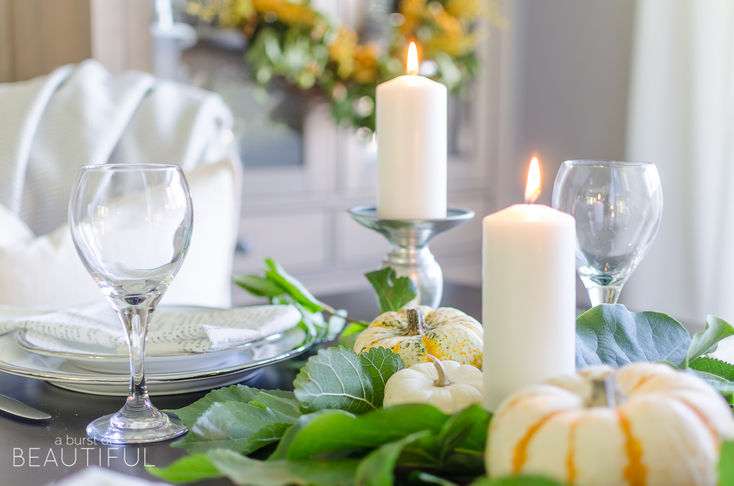 Create a simple and classic fall tablescape using mini pumpkins, fresh greenery and candles.