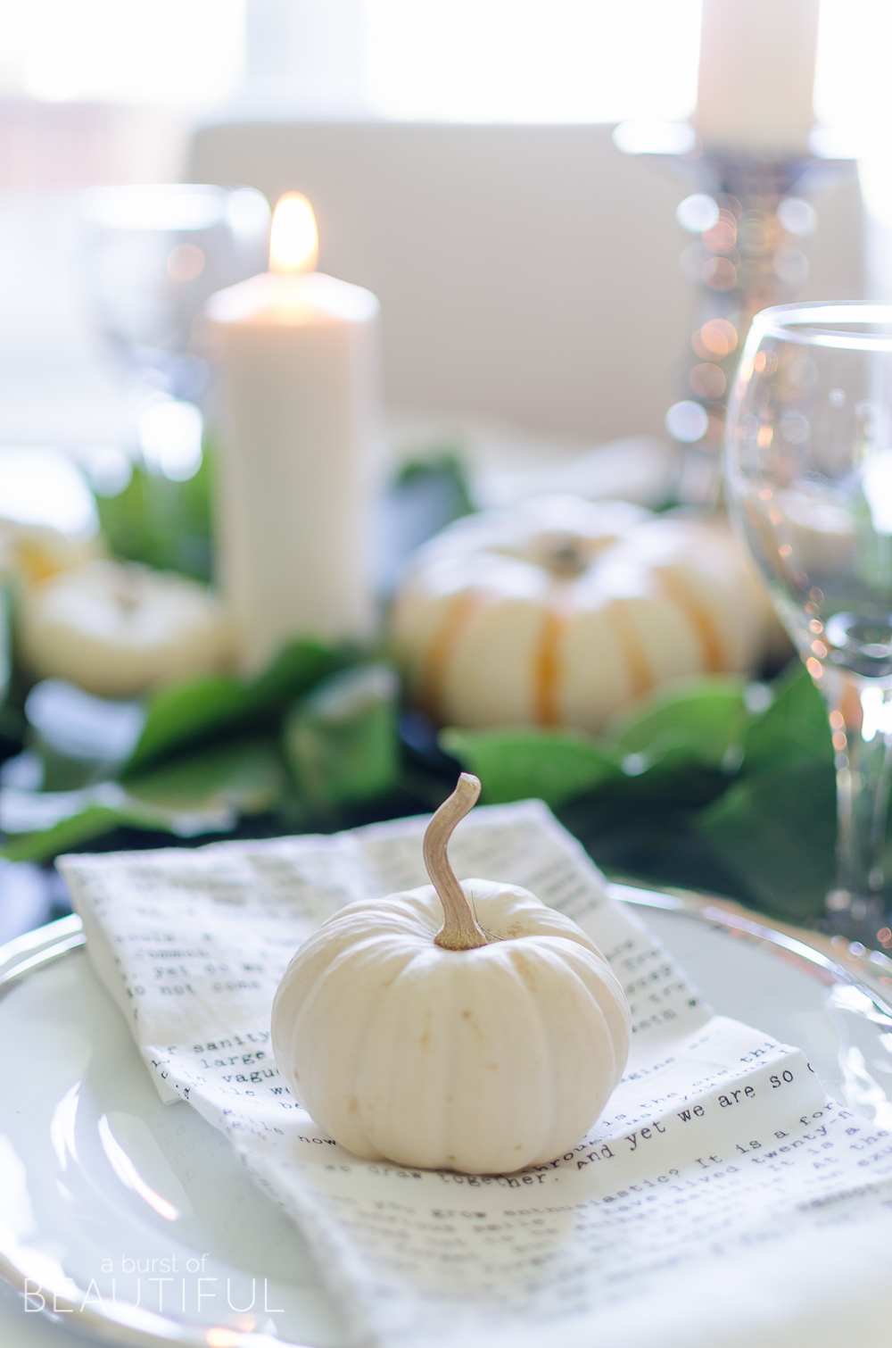 Create a simple and classic fall tablescape using mini pumpkins, fresh greenery and candles.