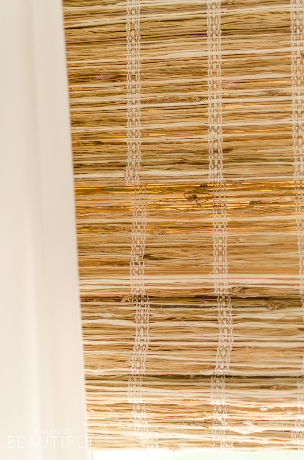 Woven wood shades add color, texture and warmth to this modern farmhouse living room. 