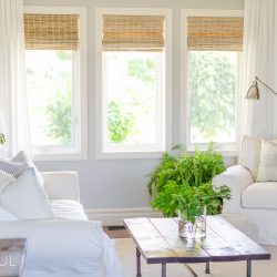 Woven wood shades add color, texture and warmth to this modern farmhouse living room.