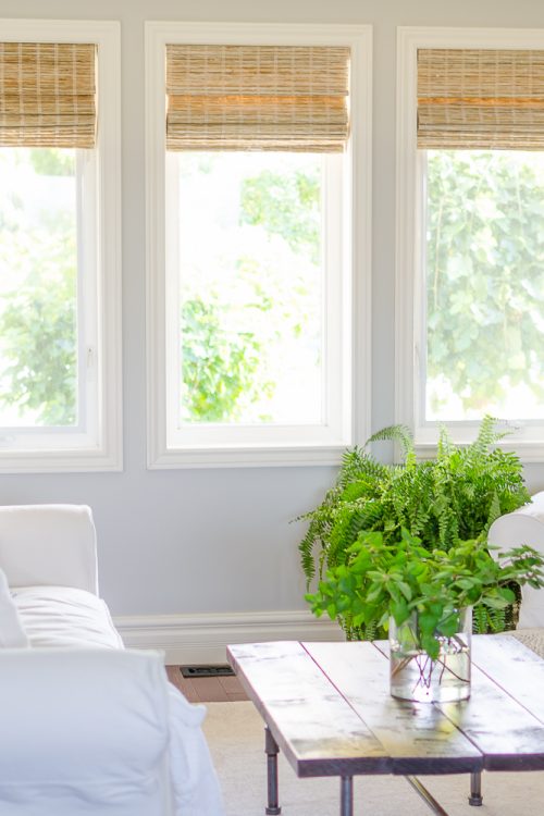 Woven wood shades add color, texture and warmth to this modern farmhouse living room.