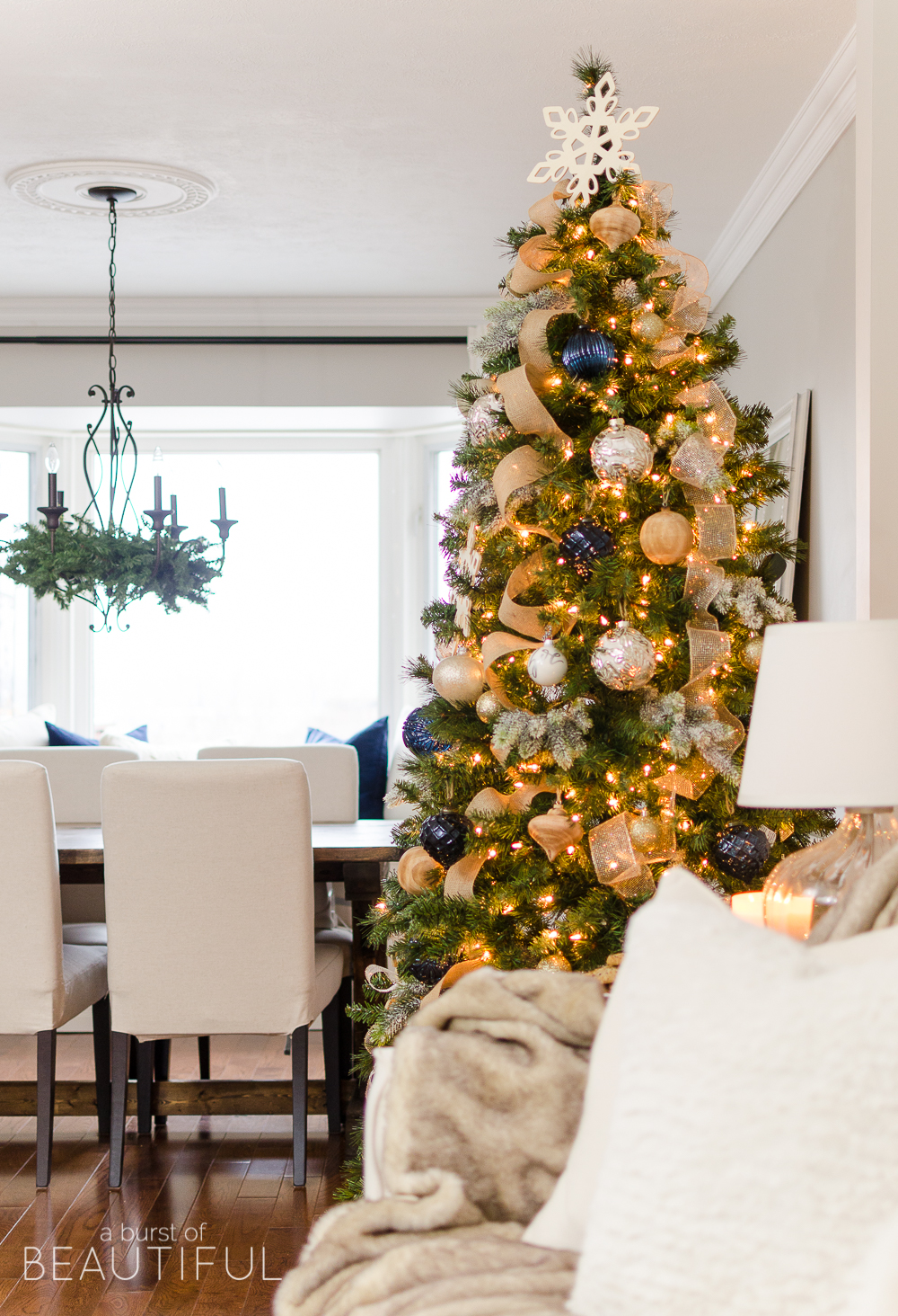 A navy and gold Christmas tree adds a touch of understated luxury to this modern farmhouse.