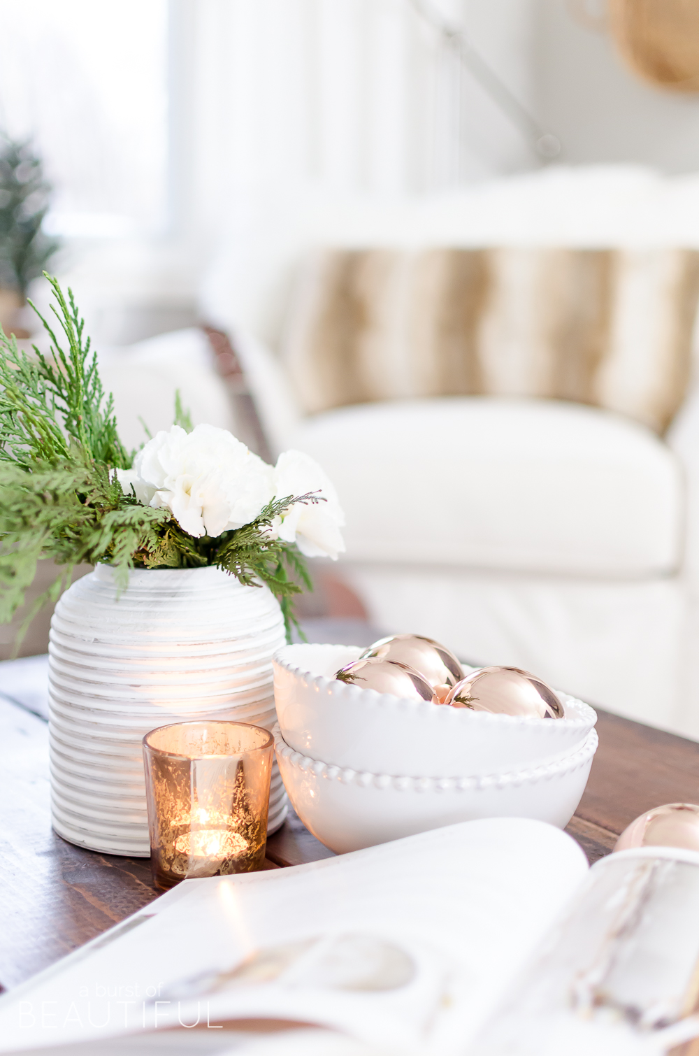 Natural wood tones, copper accessories and faux fur and velvet textiles create a cozy Christmas living room 