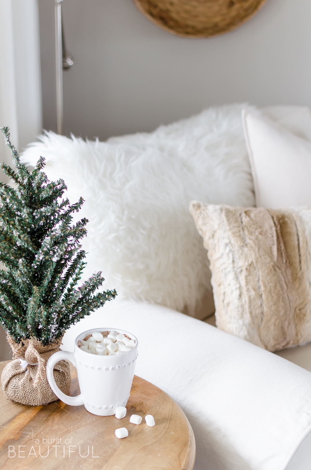 Natural wood tones, copper accessories and faux fur and velvet textiles create a cozy Christmas living room 