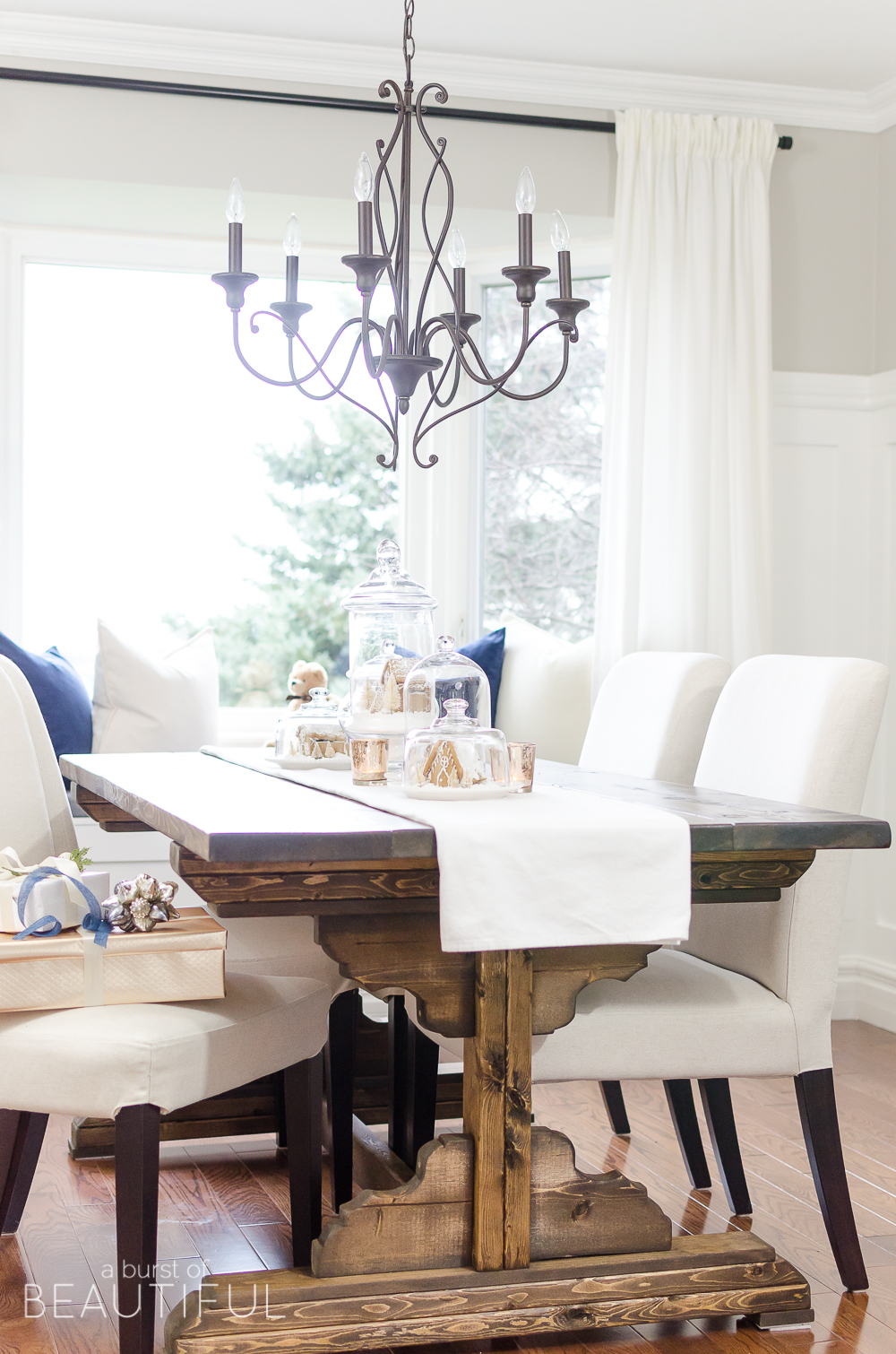 An inviting holiday dining room in this modern farmhouse is full of whimsical Christmas charm