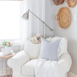 A distressed foot stool adds character to this cozy modern farmhouse. Find the project in A Touch of Farmhouse Charm by Liz Fourez.
