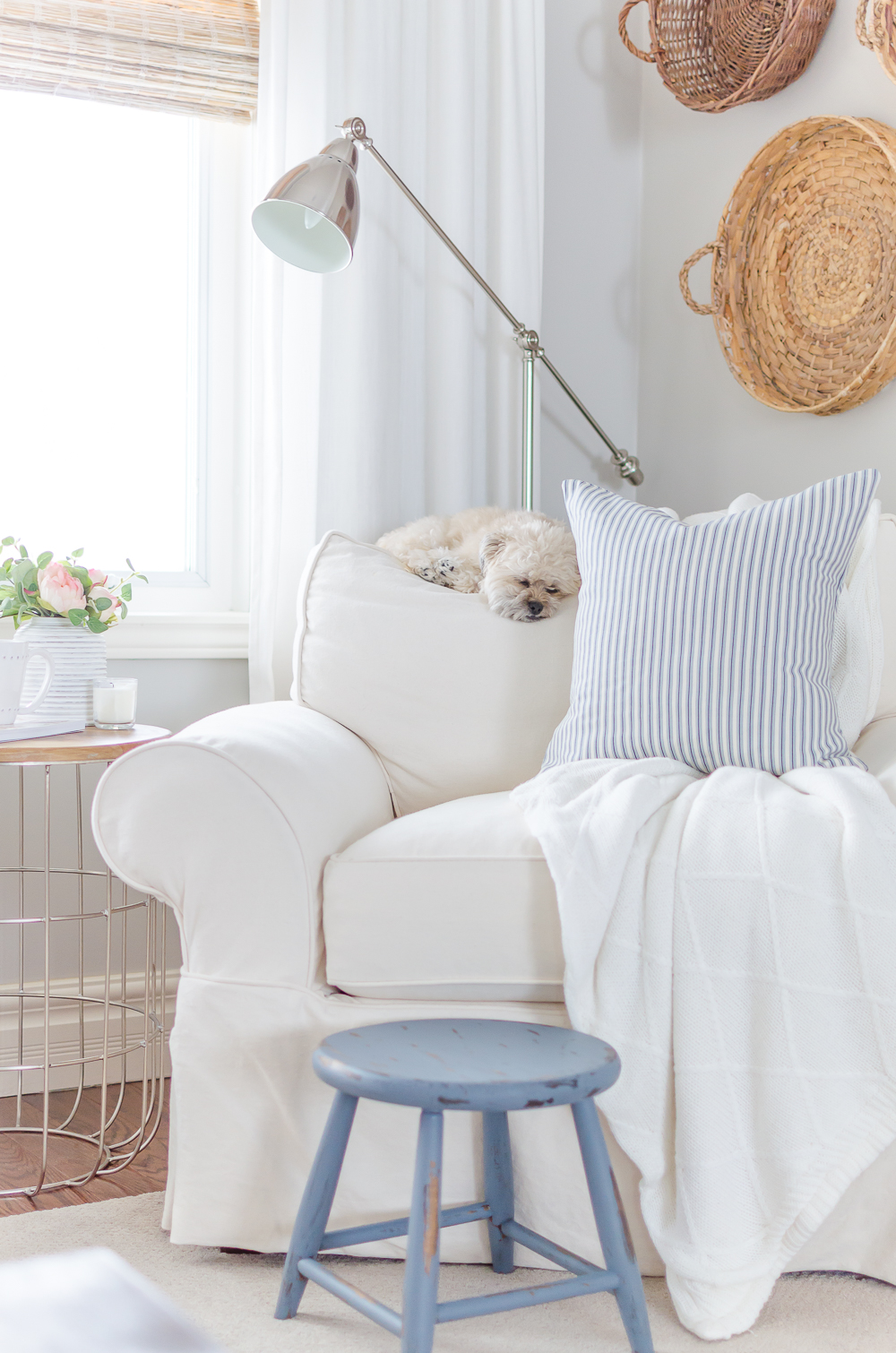 A distressed foot stool adds character to this cozy modern farmhouse. Find the project in A Touch of Farmhouse Charm by Liz Fourez.