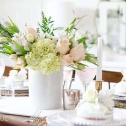 Roses, tulips and hydrangeas create the perfect centerpiece for this simple pink and gold spring tablescape.