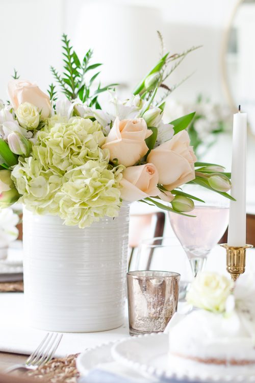 Roses, tulips and hydrangeas create the perfect centerpiece for this simple pink and gold spring tablescape.