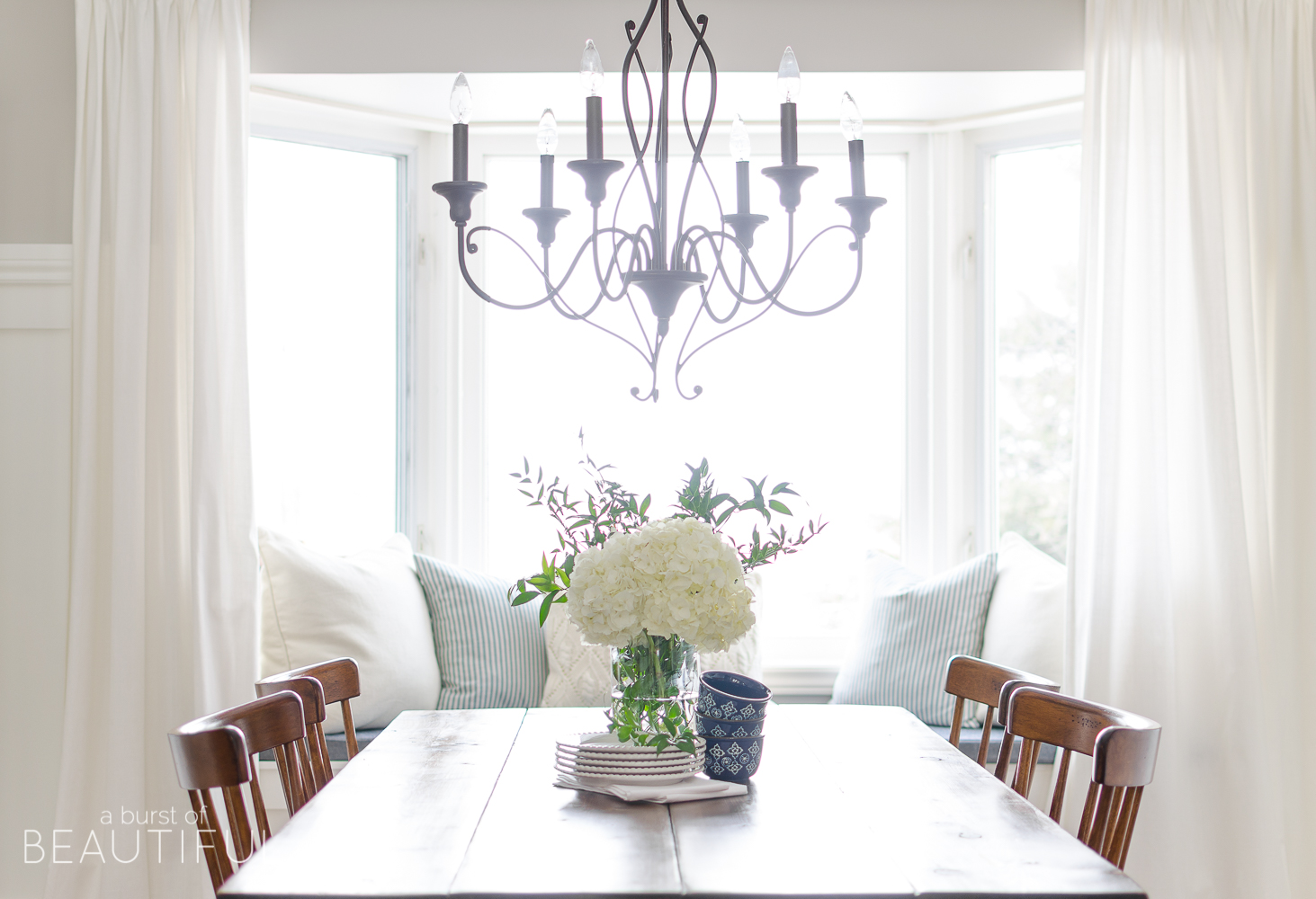 Spring Home Tour | Our Dining Room - A modern farmhouse feels bright and inviting as it embraces the spring season. Tour the full home at www.aburstofbeautiful.com. 