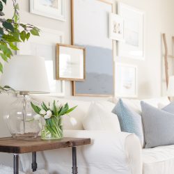 Spring Home Tour | Our Living Room - A modern farmhouse living room looks fresh and cheerful for spring with a subtle blue and white color palette and layered coastal gallery wall.