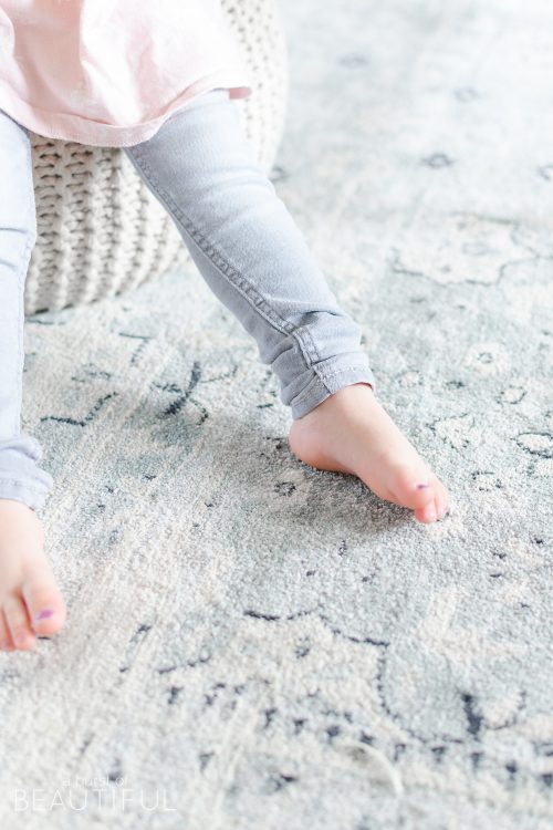 A navy blue vintage wash rug adds subtle color and pattern to this neutral modern farmhouse living room.