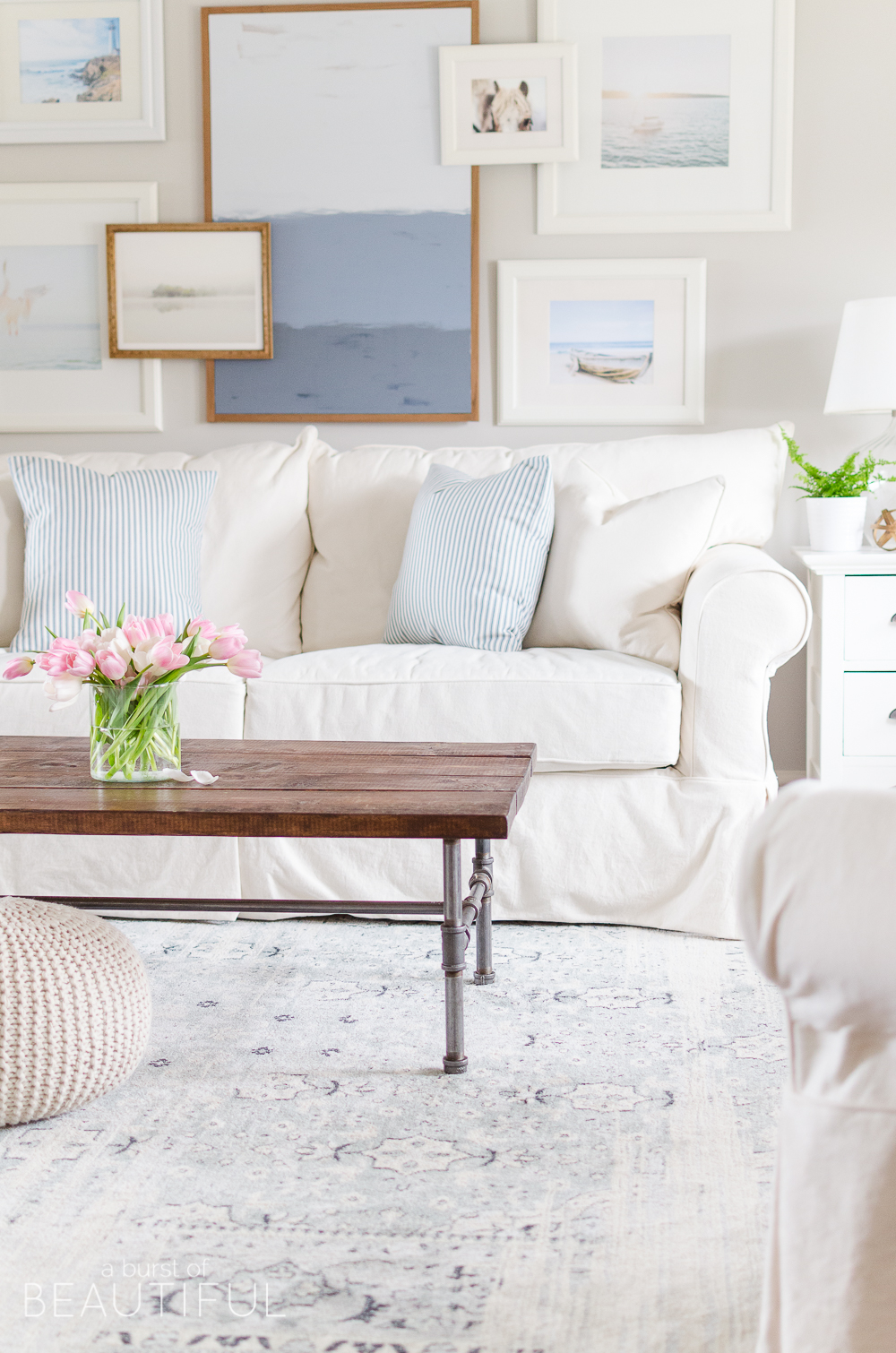 A navy blue vintage wash rug adds subtle color and pattern to this neutral modern farmhouse living room. 