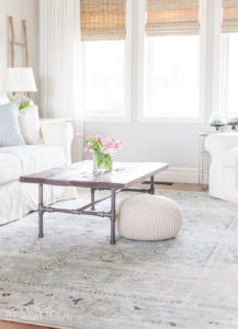 A navy blue vintage wash rug adds subtle color and pattern to this neutral modern farmhouse living room.