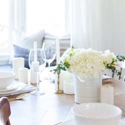 A simple spring tablescape set in a classic blue and white color palette with a centerpiece of white hydrangeas and crocuses leads to easy spring entertaining.