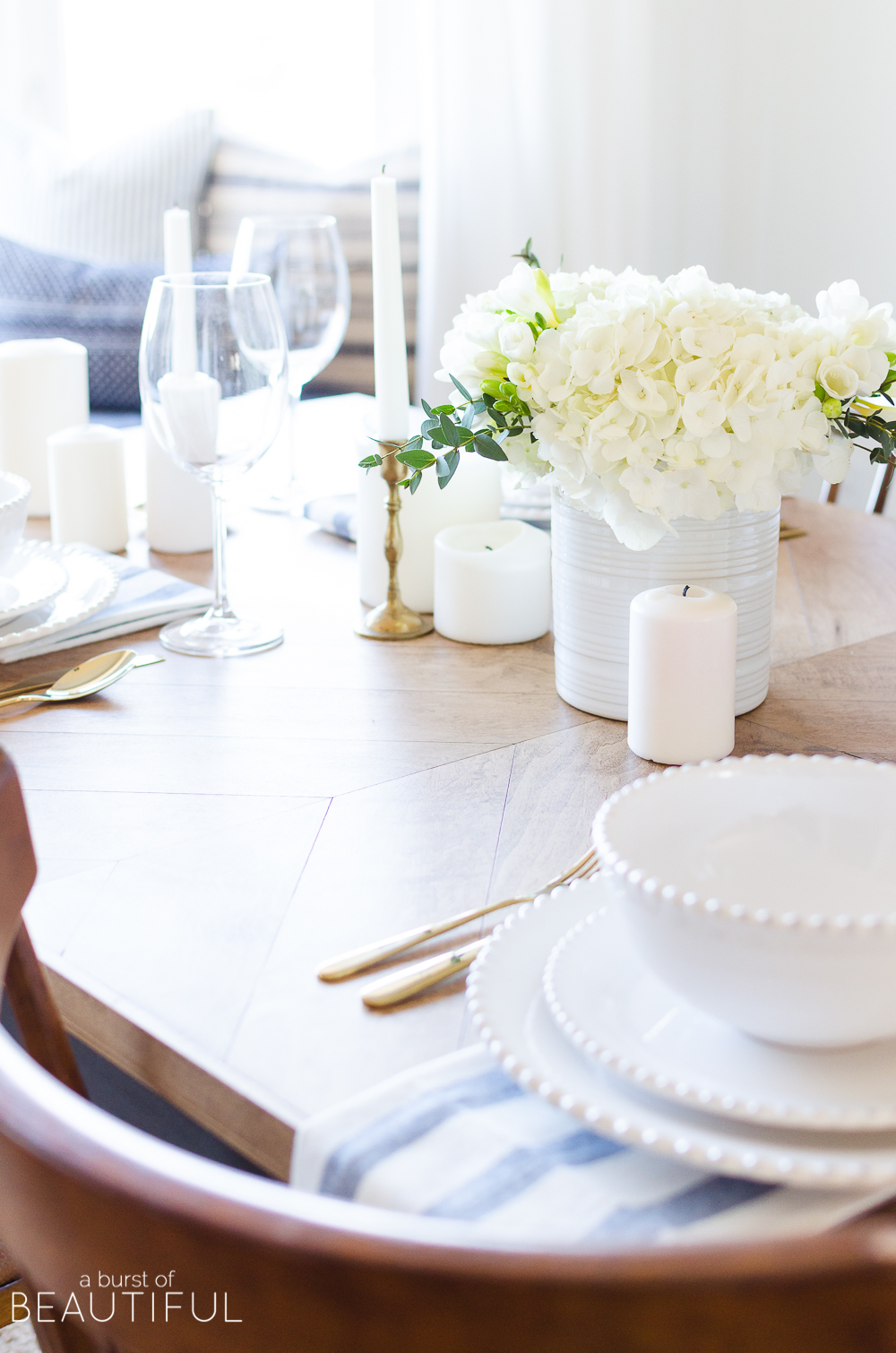 A simple spring tablescape set in a classic blue and white color palette with a centerpiece of white hydrangeas and crocuses leads to easy spring entertaining.