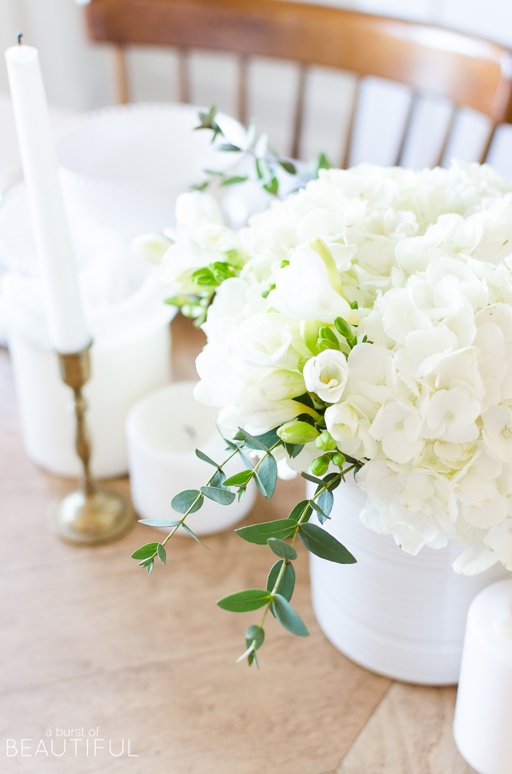 A simple spring tablescape set in a classic blue and white color palette with a centerpiece of white hydrangeas and crocuses leads to easy spring entertaining.
