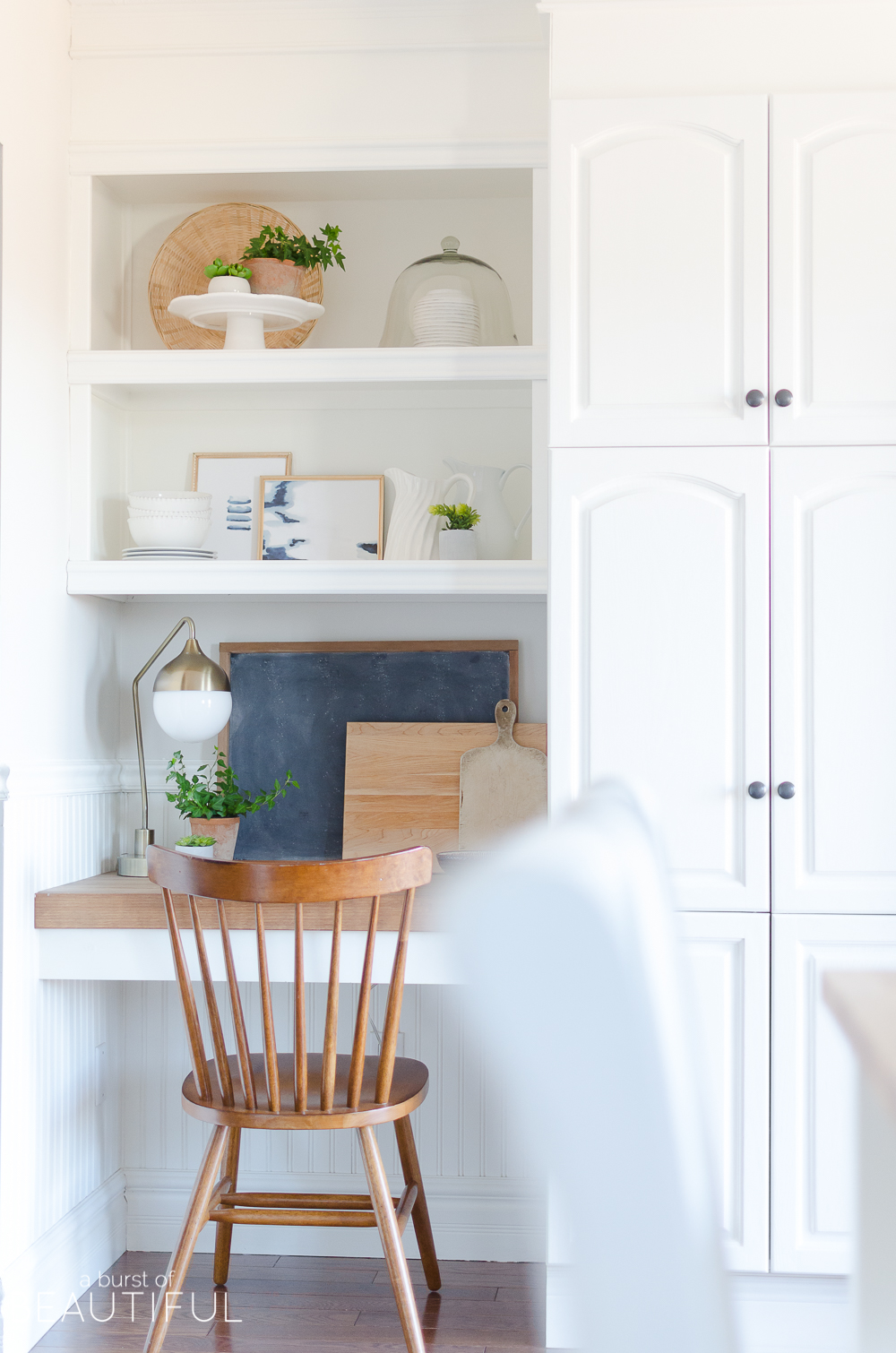 A small kitchen nook is decorated for spring with these simple and easy-to-follow steps for styling open shelving.