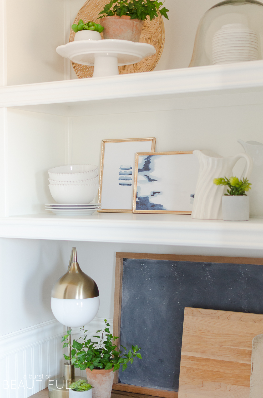 A small kitchen nook is decorated for spring with these simple and easy-to-follow steps for styling open shelving.