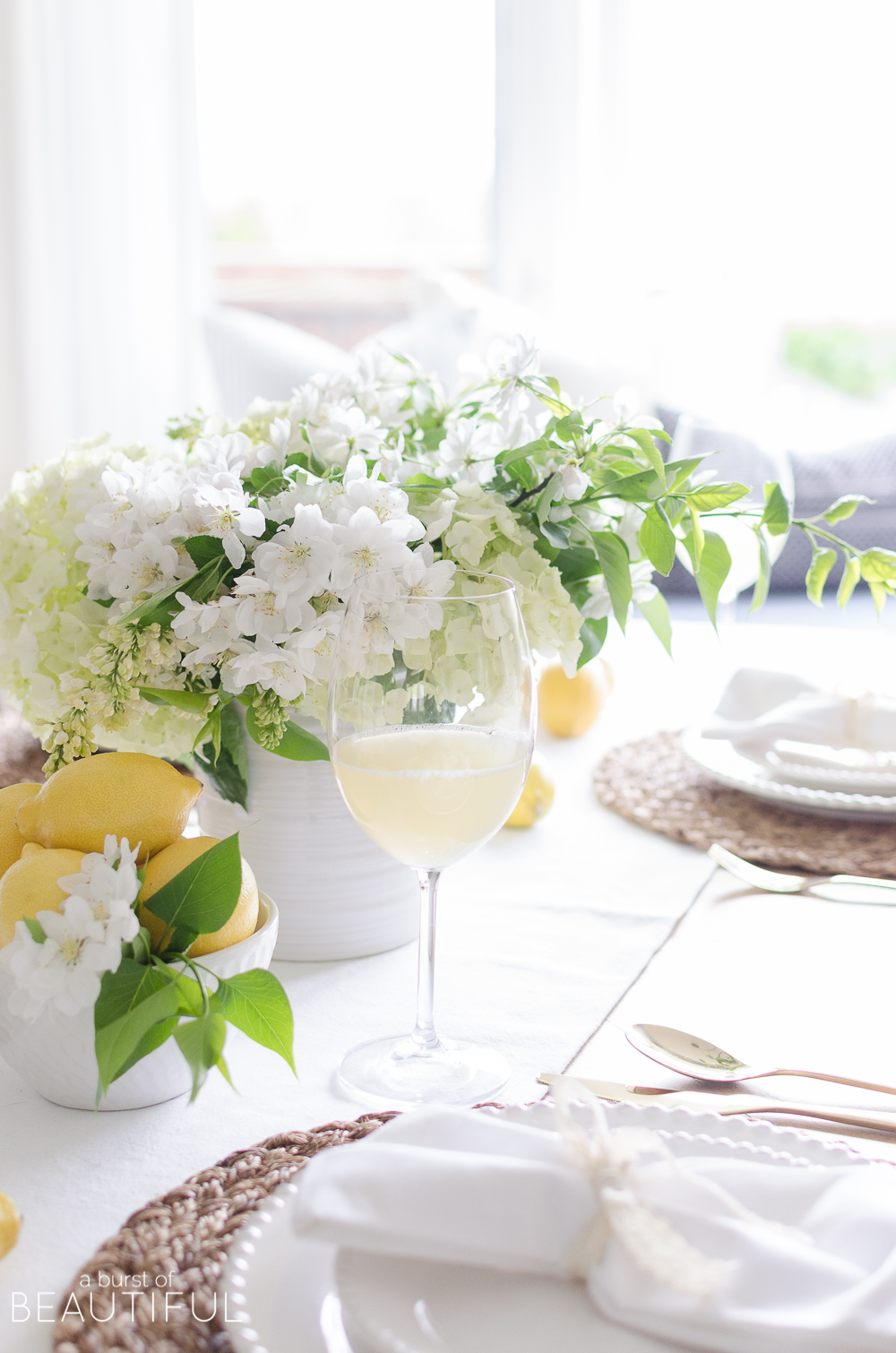 Summer entertaining is easy when you set this cheerful white and yellow summer tablescape using fresh flowers and fruit. 