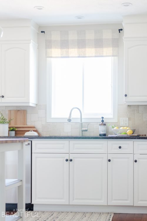 This bright and cheerful family home welcomes summer with a neutral color palette and lots of texture while mixing a modern aesthetic with classic farmhouse style