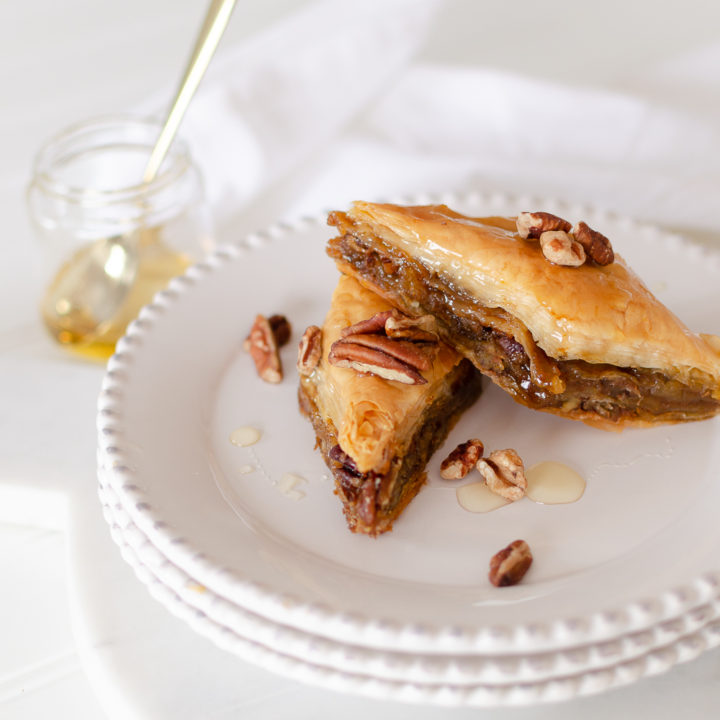 Our Pumpkin Pie Baklava is a modern variation to traditional Greek baklava recipes. Decadent pumpkin pie filling, pecans, and honey baked between layers of phyllo pastry create an irresistible fall dessert that will quickly become a seasonal favorite. 