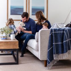 A comfortable family room, featuring a stylish mid-century modern sectional is the perfect place to relax and enjoy family life.