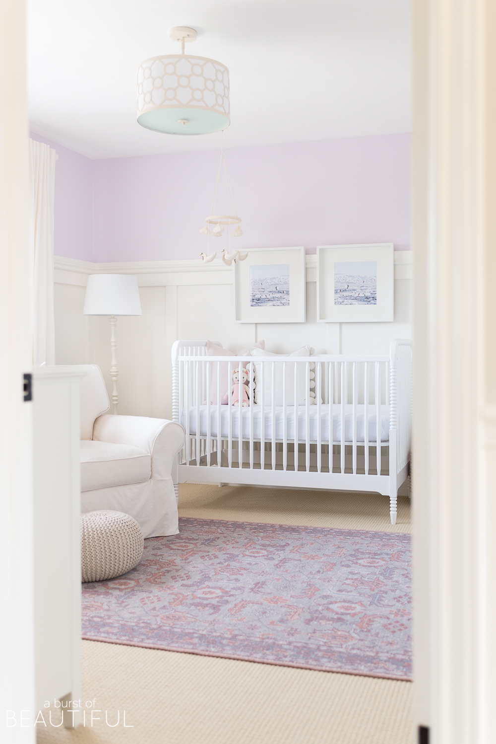 Soft shades of lavender and rose mixed with whimsical details bring this sweet and colorful nursery to life. 