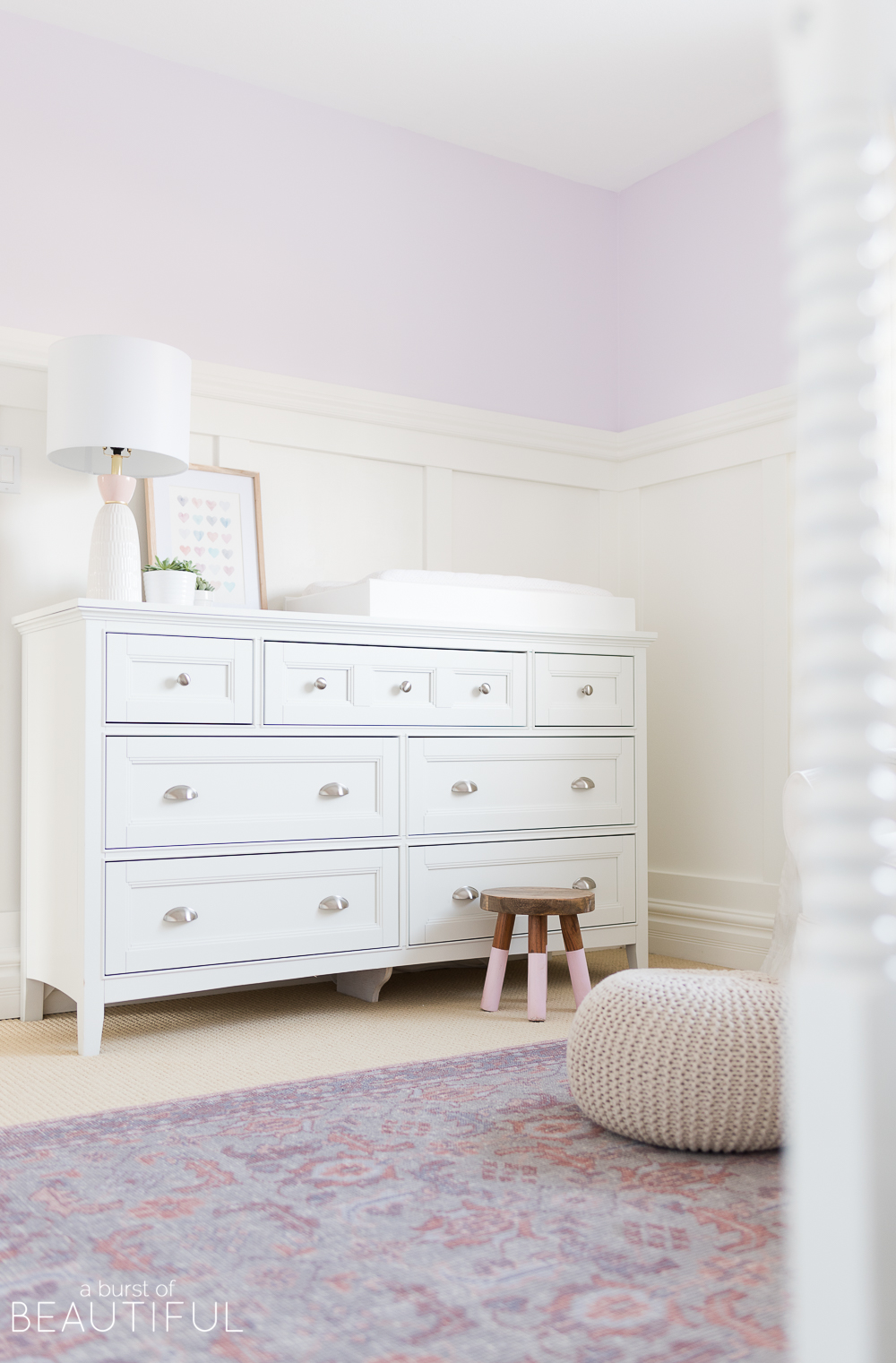 Soft shades of lavender and rose mixed with whimsical details bring this sweet and colorful nursery to life.