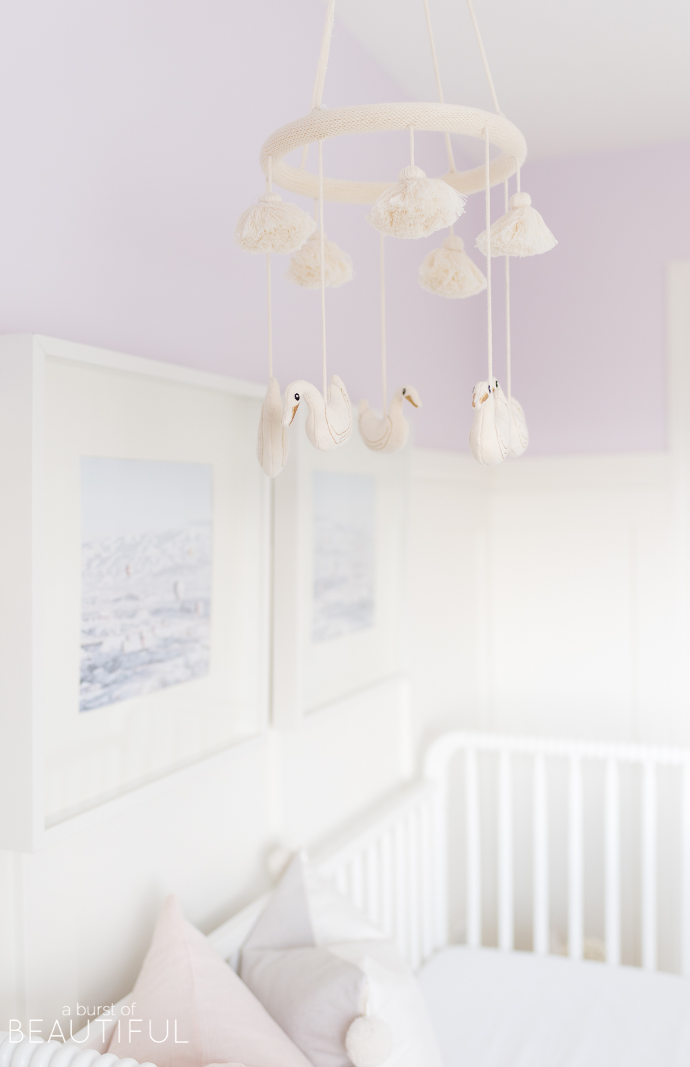 Soft shades of lavender and rose mixed with whimsical details bring this sweet and colorful nursery to life.