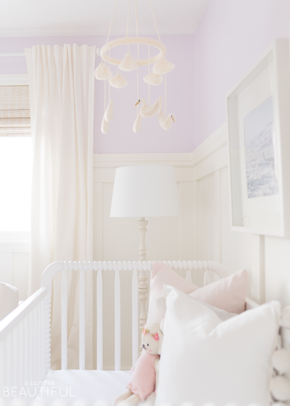 Soft shades of lavender and rose mixed with whimsical details bring this sweet and colorful nursery to life.