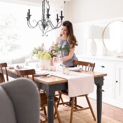 Celebrate Easter around a table set with classic white dishes, linens in pastel shades and a centerpiece full of spring blooms. 