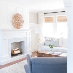 A classic craftsman style fireplace is the perfect addition to this coastal casual living room. A herringbone marble facade combined with bi-fold doors that easily open to reveal a hidden TV mix style and convenience. We are sharing the free plans here. 