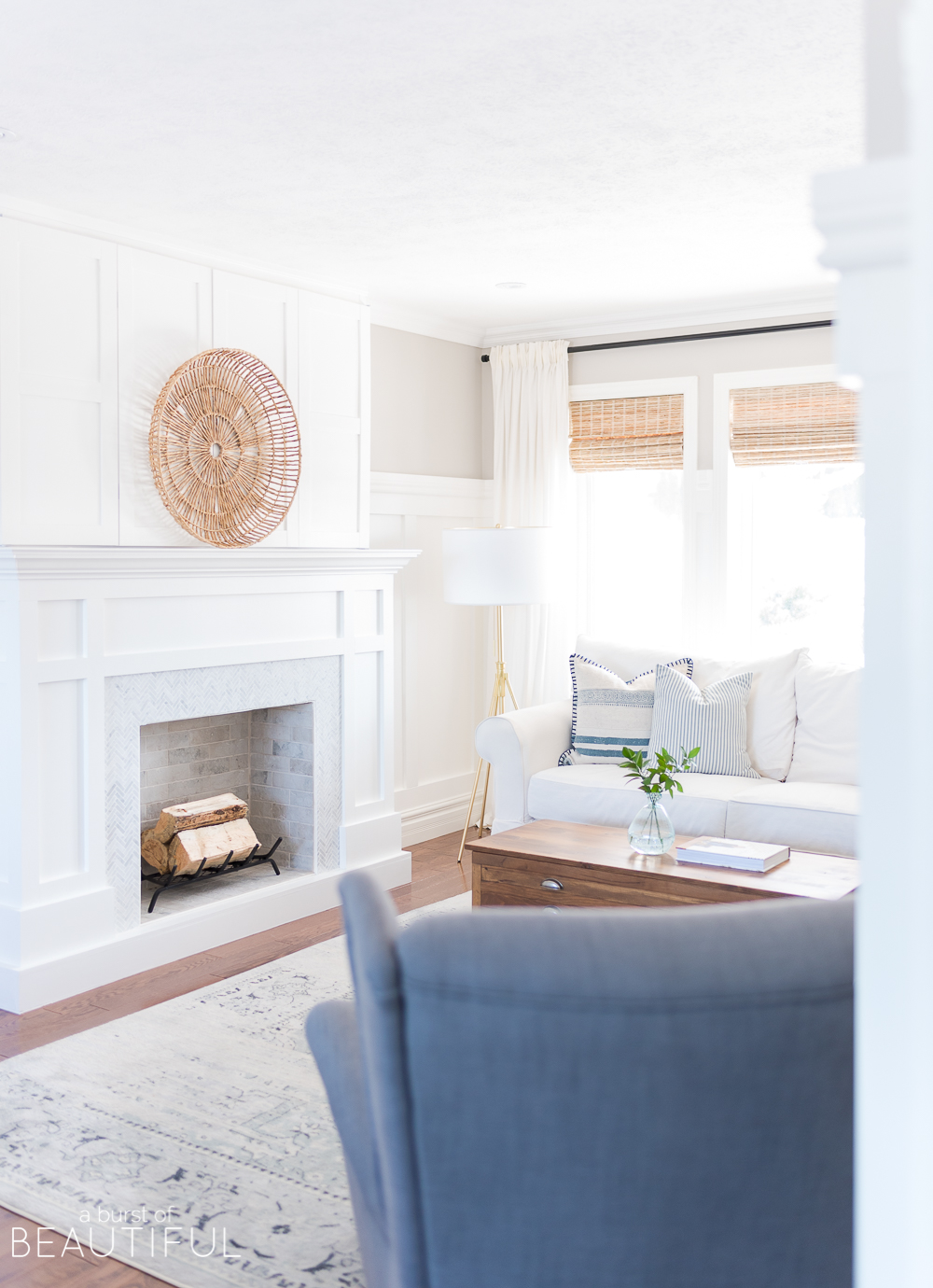 A classic craftsman style fireplace is the perfect addition to this coastal casual living room. A herringbone marble facade combined with bi-fold doors that easily open to reveal a hidden TV mix style and convenience. We are sharing the free plans here. 
