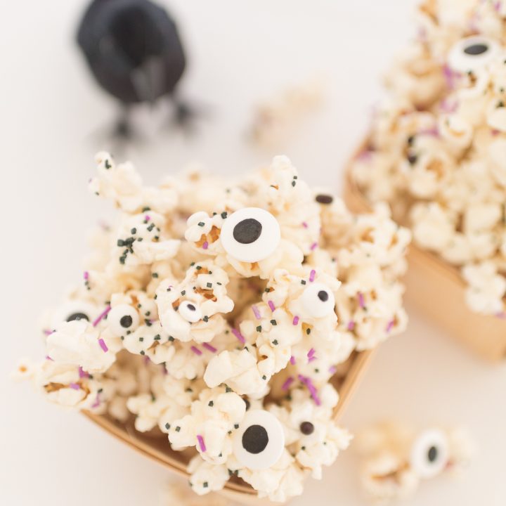 Halloween Monster popcorn drizzled in melted white chocolate and mixed with sprinkles and candy eyeballs