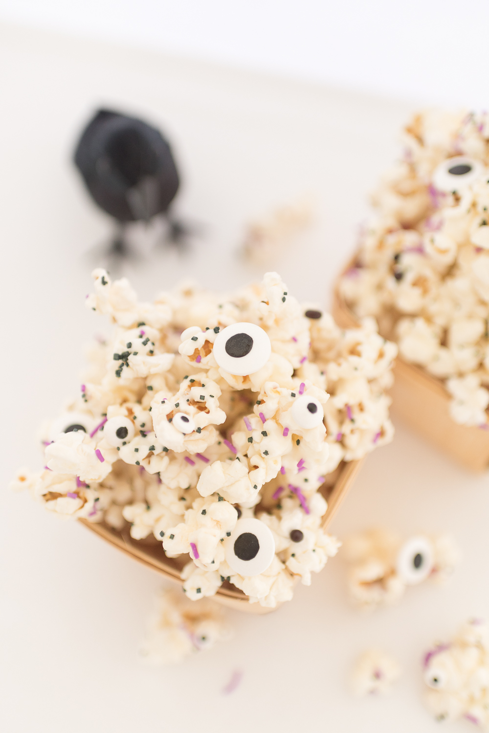Halloween Monster popcorn drizzled in melted white chocolate and mixed with sprinkles and candy eyeballs